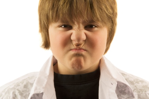 boy scruntching nose